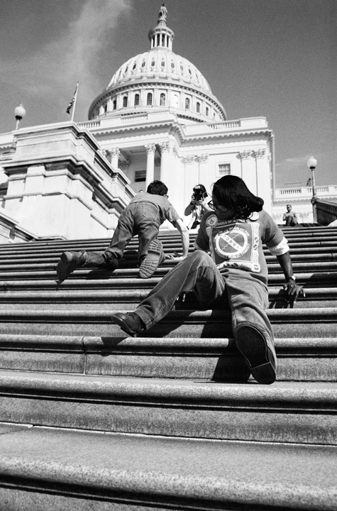 Members of ADAPT crawl up the steps to the U.S. Capitol.
